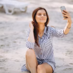 portrait-young-woman-with-phone-beach_1303-9825
