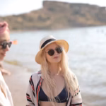selective-focus-shot-two-young-women-with-glasses-beach_181624-33416